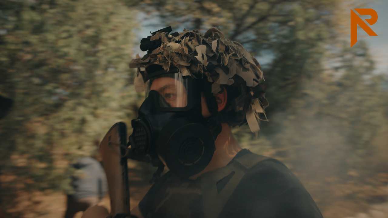 Man in the woods with gas mask and full kit