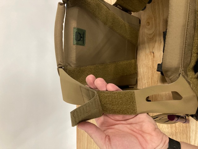 Starting to separate the shoulder strap from the velcro on the Invictus plate carrier from Armored Republic